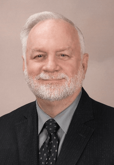 white-haired man wearing black suit